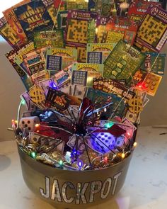 a metal bucket filled with lots of cards and lights