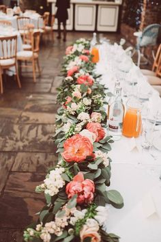 a long table with flowers and candles on it