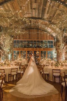 a bride and groom are standing in front of their wedding reception tables at the lodge