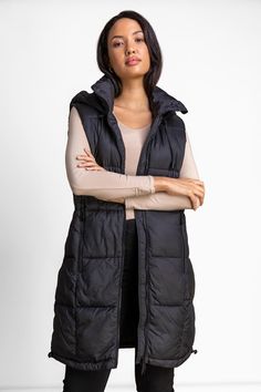 Padded Longline Hooded Gilet from Roman. Sleek and stylish, this cosy padded quilt longline gilet is a wardrobe must-have that's perfect for the colder months ahead. Finished with a high neck, this padded gilet features a matching colour zip, functional pockets, draw cord hood and a quilted body to keep you well insulated. Pair with jeans and a jumper for the ultimate Autumn vibes outfit. Hooded Gilet, Vibes Outfit, Padded Gilet, Oasis Fashion, Autumn Vibes, Fashion Face, Fall Vibes, Long A Line, Color Matching