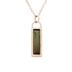 "details  ✧ Pendant size ~ 19.5mm x 6.75mm ✧ Green Tourmaline ✧ Chain Length ~ 18 inches with the option to wear at 16 inches ✧ Diamond Cut Boston Link Chain ✧ 14k Yellow Gold ~ setting & chain description Baguette-cut gemstones have always been a favorite cut of mine, but an elongated baguette really makes my heart pitter-patter.  The dramatic shape mixed with the deep dark green color of this tourmaline makes for a rich pendant. Set vertically, this pendant hangs from an 18-inch chain diamond Black Tourmaline Necklace, Chain Diamond, Dark Green Color, Tourmaline Pendant, Dainty Chain, Rose Quartz Ring, Tourmaline Necklace, Green Gems, Yellow Gold Setting