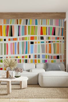 a living room filled with furniture and a colorful wall