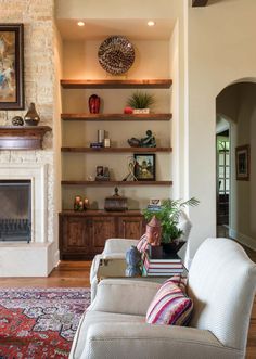 a living room filled with furniture and a fire place