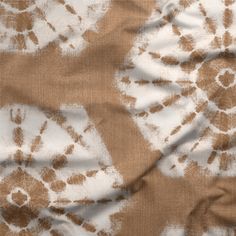 the fabric is brown and white with an abstract design on it's back side