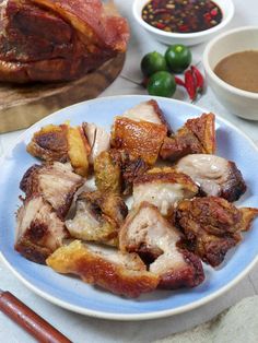 a plate full of meat and some dipping sauces