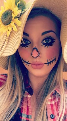 a woman with painted face and sunflowers on her head wearing a cowboy hat