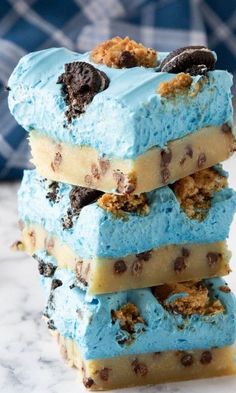 three ice cream bars stacked on top of each other with cookies and oreo chips