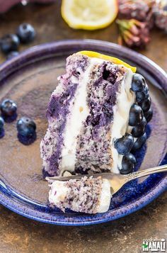 a slice of blueberry cheesecake on a plate with a fork