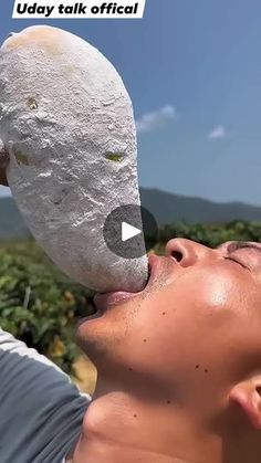 a man is holding up a large rock to his face with the caption today talk official