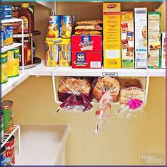 an organized pantry with food items on the shelves and in bags hanging from the ceiling