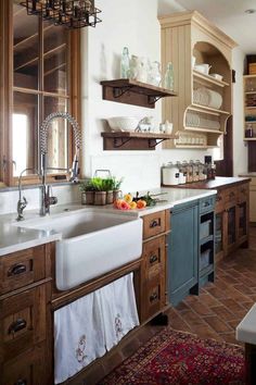 a kitchen filled with lots of wooden cabinets and white counter tops next to a sink