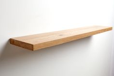 a wooden shelf hanging on the wall