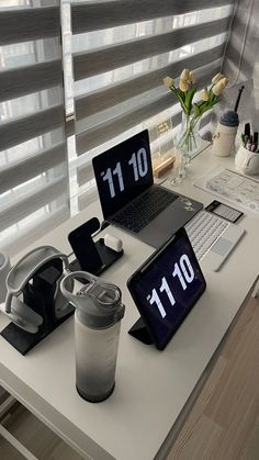 a laptop computer sitting on top of a white desk