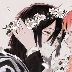 two people with flowers in their hair and one is holding the other's face