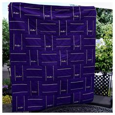 a purple blanket sitting on top of a metal table