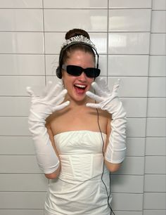 a woman in a white dress wearing headphones