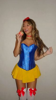 a woman dressed as snow white holding an apple