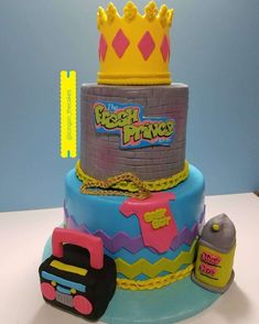 a birthday cake with a toy truck and crown on top