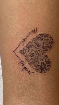 a woman's leg with a fingerprint tattoo on the side of her thigh