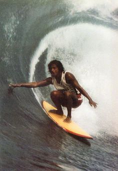 a man riding a wave on top of a surfboard