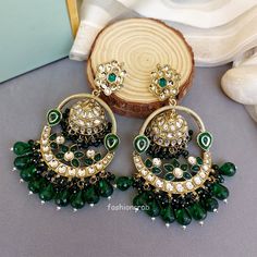 A pair of golden-toned Vaani Jhumka Earrings – Green Earrings for Girls with hanging pearls. Size & Other Details Length :  11.5cm Weight : 34gm/pc Material  : Alloy, Pearl, Kundan, Stone work Shape : Dome Shaped Attire :  Lehenga Choli, Salwar Suit, Kurti, Saree, Flared Dress Green Pearl Earrings For Festivals, Green Heavy Dangle Chandbalis, Pearl Jhumkas, Green Pearl Earrings, Suit Kurti, Celebrity Jewelry, Chandbali Earrings, Earrings For Girls, Bollywood Style