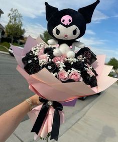 a person holding a bouquet of flowers and a stuffed animal