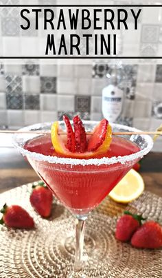 strawberry martini in a glass with strawberries on the rim