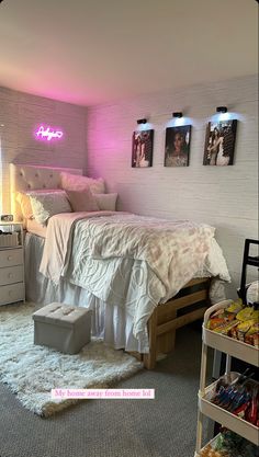 a bed room with a neatly made bed and some pictures on the wall above it