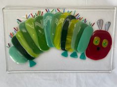 a glass plate with a very cute looking caterpillar on it