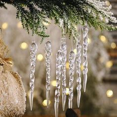 an ornament hanging from a christmas tree with lights in the background and decorations