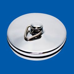 a white lid with a silver handle on it and a blue background in the back ground