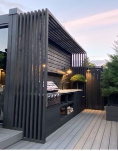 an outdoor kitchen on a deck in the evening