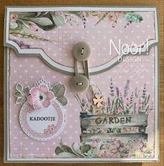 a close up of a card on a table with buttons and flowers in the background