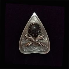 "This is a handmade, solid sterling silver ring. The ring is in the shape of a planchette with delicate hands cradling a natural gemstone. The ring measures 2 inches long and 1 3/8 inch wide at the widest point. My Maker's Mark 'ASA' is on the back of the ring.  It is also stamped \"Sterling\". It is quite a statement piece!  You will feel the magic when you wear this ring!  I'm very proud of this piece and I'm thrilled to be able to offer it for sale. The ring comes in your choice of ring size Unique Silver Ring For Memorial, Artisan Silver Teardrop Rings, Collectible Hand Forged Sterling Silver Rings, Planchette Jewelry, Delicate Hands, Occult Witch, Witch Rings, Sweet Ring, Witch Jewelry