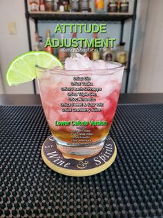 a drink sitting on top of a table with a lime wedge in the middle of it