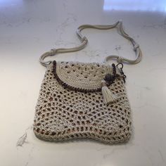 Crochet Bag By The Sak. Cream Color With Bronze Gold Lining. Detail Around Flap. Tassel. Zip Compartment Place For Credit Cards/ Glasses. Nwot Beige Crochet Satchel With Top Carry Handle, Beige Crochet Satchel Bag With Handles, Bohemian Beige Crochet Crossbody Bag, The Sak Handbags Crochet, The Sak Handbags The Sak, The Sak Handbags, The Sak, Cream Color, Crochet Bag