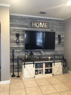 a large flat screen tv mounted to the side of a wall in a living room