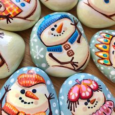 several painted rocks with snowmen on them