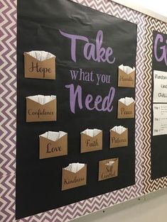 a bulletin board that says take what you need with some paper bags attached to it