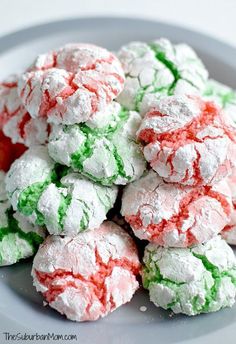 a plate full of colorful powdered sugar cookies