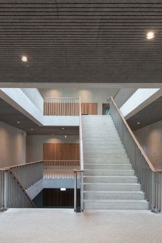 an empty building with stairs leading up to the second floor