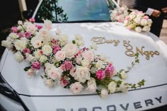 wedding car decorated with pink and white flowers for the bride's special day in may