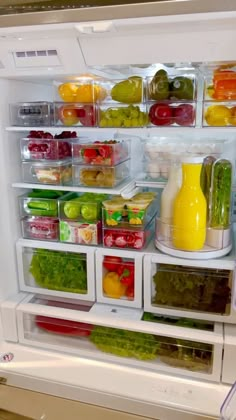 an open refrigerator filled with lots of different types of vegetables and fruit in it's doors