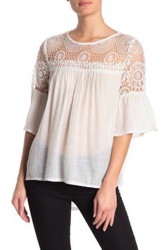 Three-quarter sleeves and crochet lace knit detailing accentuates this dainty blouse. Crew neck. 3/4 length sleeves. Crochet lace knit detail. Contrast details. Solid. Approx. 30" length (size M). Imported Feminine Crochet Top With Lace Patchwork For Spring, Feminine Crochet Lace Blouse, Feminine Lace Patchwork Crochet Top For Spring, White Crochet Top With Lace Collar, Short Sleeve Crochet Top With Lace Patchwork For Spring, Feminine Crochet Top With Lace Trim, Spring Crochet Top With Lace Trim For Brunch, Spring Lace Top With Pointelle Knit, Spring Pointelle Knit Lace Top