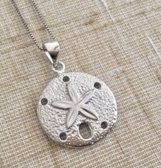 ".925 Sterling Silver Hawaiian Beach Ocean Sand Dollar Necklace. The size is 20MM, about 3/4\". FREE Italian Sterling Silver Diamond cut box Chain Included In your choice of length. --Part of our popular Sand Dollar collection in our Maui stores. The Highly-reflective Sterling Silver finish provides the expensive look of Fine Jewelry. This may also be worn on your White Gold chains. The finish is also very durable and maintains its stunning appearance over a long period of time. --Packaged ready Silver Engraved Necklace For Beach, Silver Round Beach Necklace, Silver Necklace For Beach, Silver Pendant Necklace For Vacation, Silver Pendant Necklaces For Vacation, Nickel Free Silver Jewelry For Vacation, Nickel-free Silver Jewelry For Vacation, Tropical Necklace, Whale Tail Necklace