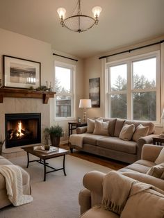 a living room with two couches and a fire place in it's center