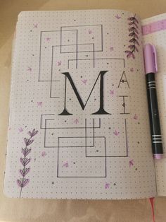 an open notebook with the letter m on it