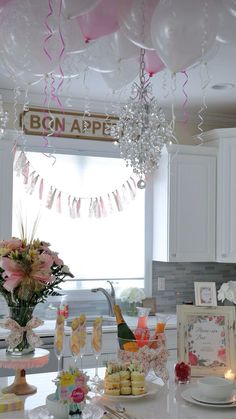 the table is set for a bridal party with balloons and confetti on it