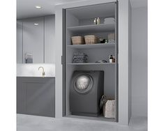 a washer sitting inside of a gray cabinet next to a sink