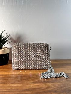 Dazzling nights call for an exquisite companion. This beaded evening bag adds the perfect touch of glamour to your ensemble. Dimension: Width: 18cm Height: 13cm Depth: 6cm The bag comes with two detachable handles. Feel free to contact me for any questions. Glamorous Beaded Evening Bag, Sparkling Rectangular Clutch For Party, Rhinestone Pouch Evening Bag For Parties, Glamorous Evening Bag With Chain Strap For Gift, Glamorous Party Shoulder Bag With Pearl Handle, Glamorous Evening Bag With Pearl Handle, Glamorous Evening Shoulder Bag With Pearl Handle, Glamorous Beaded Evening Bag For Formal Occasions, Glamorous Beaded Evening Bag For Formal Events